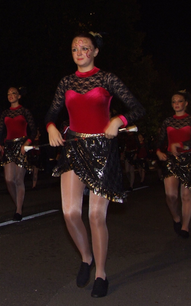 Brunette Majorette wearing White Opaque Shiny Pantyhose and Black Sneakers